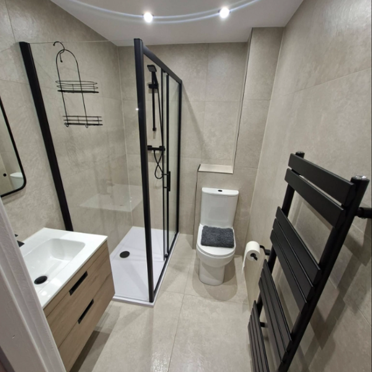 Clean modern bathroom with shower enclosure and tidy fittings