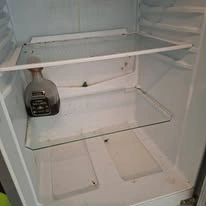 Before cleaning: refrigerator interior with visible marks and residue